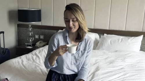 Young Pretty Businesswoman Drinking Coffee During Breakfast in Hotel 30s