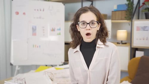 Woman Reacts with Shock and Surprise in Office