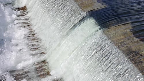 De l'eau s'écoule sur le déversoir d'un petit barrage