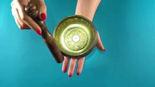 Singing Bowl Being Struck with Mallet