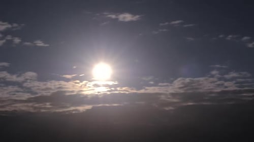 Shining sun and sunbeams through clouds. Timelapse