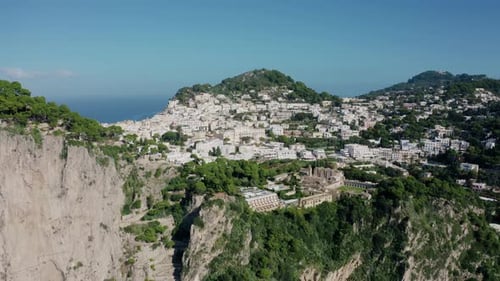 Aerial Drone View Revealing Hillside Town in Capri Island with White Buildings Located on Large and