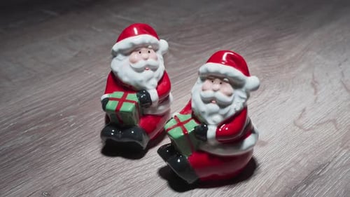 Pair of Ceramic Santa Figures Holding Gifts