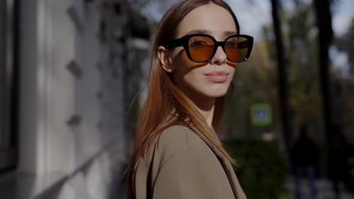 Stylish Young Woman in Sunglasses Enjoying Sunny Day in the City