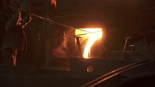 Molten Metal is Expertly Poured in an Industrial Foundry Showcasing Skilled Craftsmanship Stock Clip