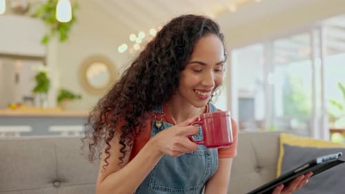 Woman Relaxing at Home Using Tablet and Drinking