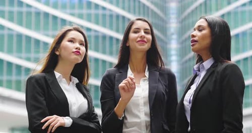 Confident Young Women Discuss Business in City