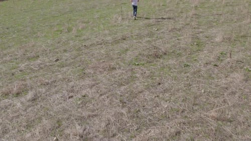 Aerial view of person walking in autumn countryside, Italy.