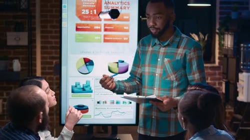 Business Team Analyzing Data in Evening Meeting