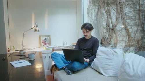 Young Adult Working on Laptop at Home Indoors