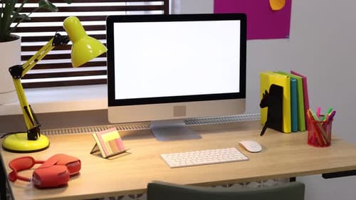 Blank Screen Computer Monitor on Desk with Lamp