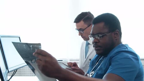 Doctor and Surgeon Talking Near Window Medical Workers in Hospital Office Day Light Healthcare