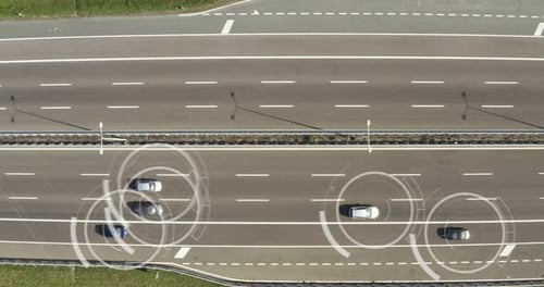 Aerial view of a highway where cars pass to go to the city and a futuristic graphic appears. Conce