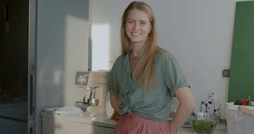 Woman Smiling in Bright Modern Kitchen at Home