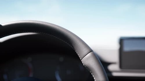 Close-Up Of Car Steering Wheel And Dashboard While Driving