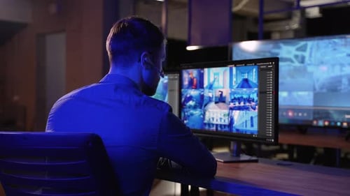 Security Officer with Headset in System Control Room Answer Phone Call