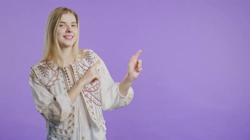 Woman Points Left with a Smile, Studio Shot