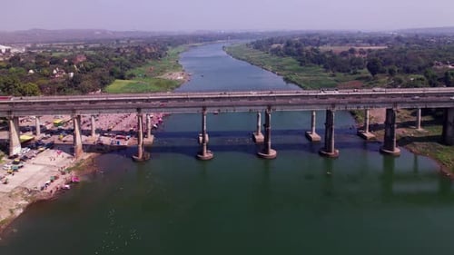 Narmada river with national highway bridge and greenery at Tilwara ghat, jabalpur, madhya pradesh, i