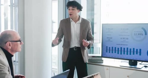 Talking, presentation and man in meeting, financial agency and graphs for company revenue