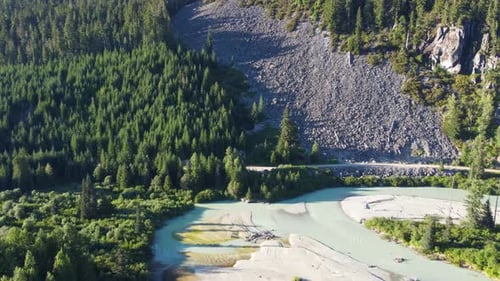 Aerial Drone Pushing Dolly Shot of Soo River and Stones on HIllside 4K