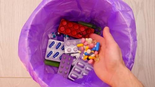 Throws Medicine Pills Into the Trash