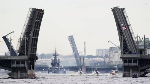 A Lot of Warships Goes Along the Neva River Under Open Bridges at the Time of the Celebration of the