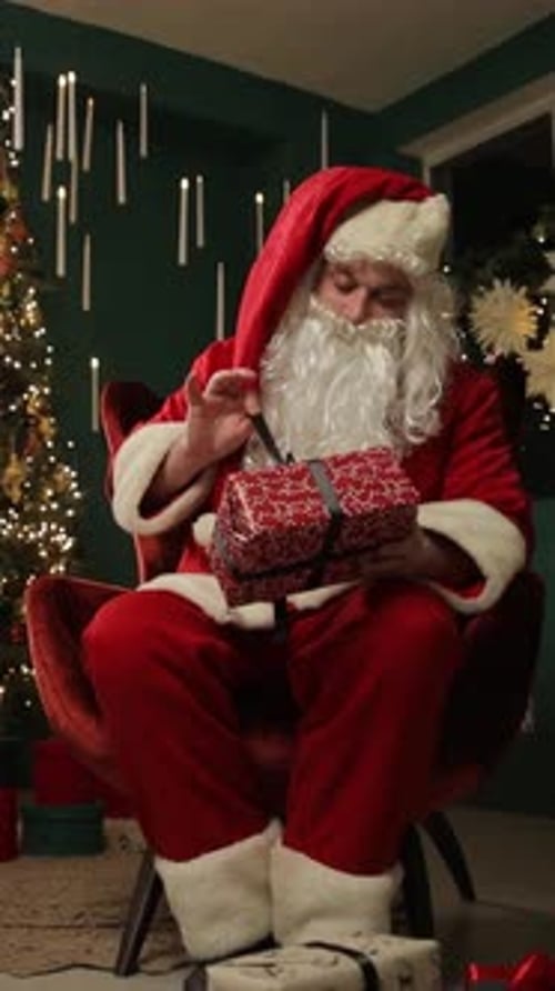 Santa Claus Sitting and Opening a Christmas Gift