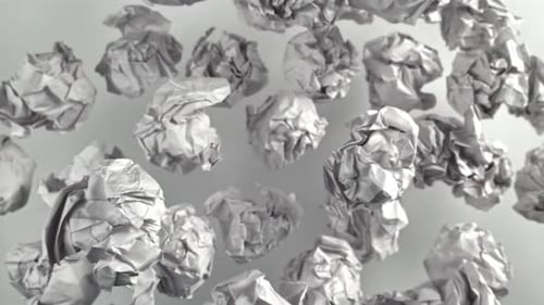 Crumpled Paper Flies Up and Falls on a White Background Filmed on a Highspeed Camera at 1000 Fps