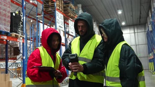 Warehouse Workers Managing Inventory in Cold Storage