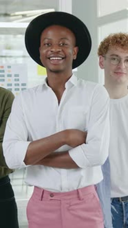 Close Up Portrait of Likable Smiling Satisfied Successful Multiethnic Men Workmates Looking at