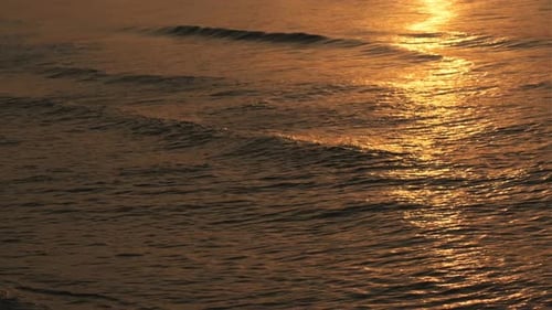 Wave splashing in sunrise or sunset on a tropical beach.