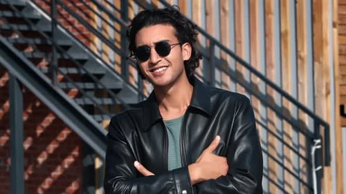 Smiling Man Posing in Leather Jacket Outdoors