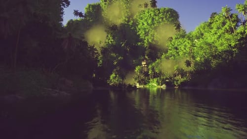Evening Sunlight Spreads Amber Hues Across Peaceful River Scenery