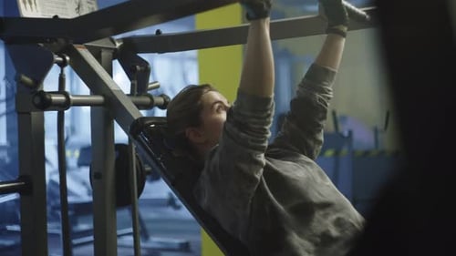 Beautiful Caucasian Woman Working Out on the Exercise Machine in the Gym