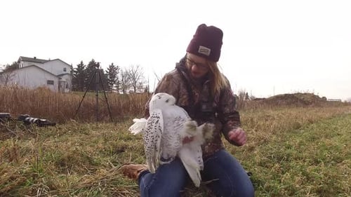 Young Woman Holding a Beautiful Snowy Owl