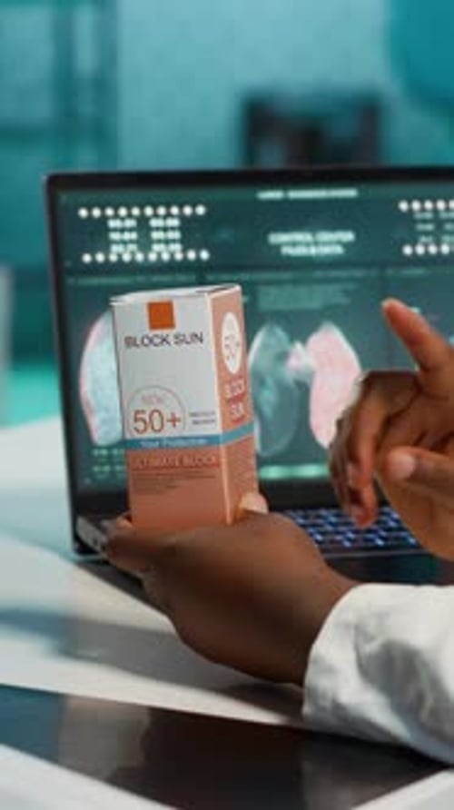 Doctor Holding Sunscreen Box in Clinical Laboratory Setting