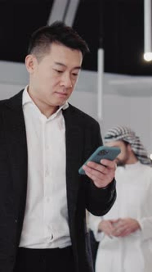 Young Adult Using Smartphone in Business Setting