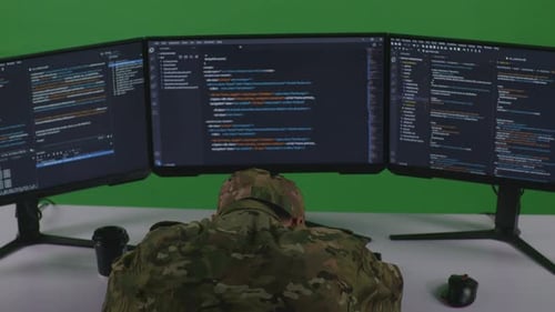 Back View Of Tired Asian Man Soldier Sleeping While Write Code With Multiple Screens In Green Screen