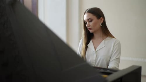 Young Woman Plays Piano