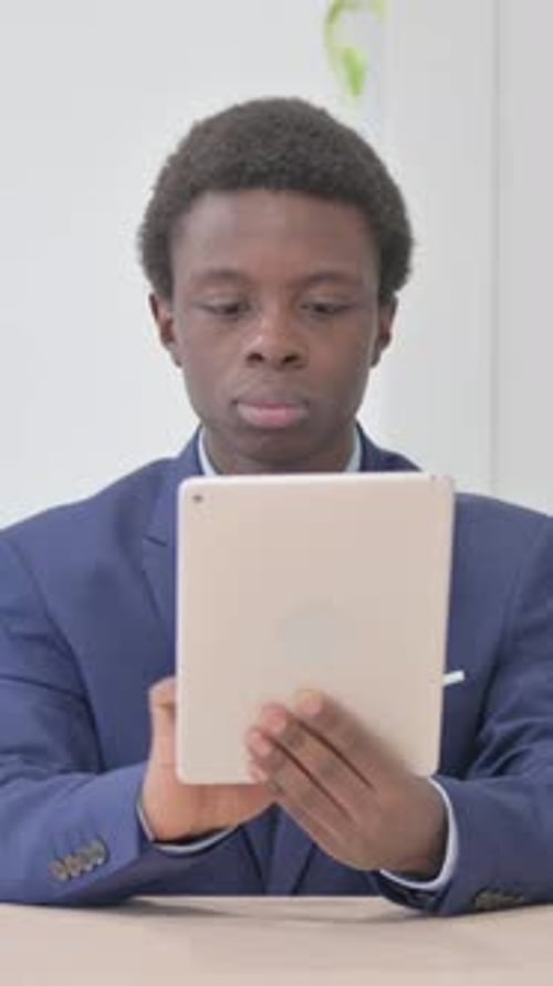 Young Adult using Tablet Device Indoors