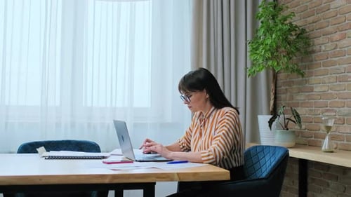 Middleaged Business Woman Office Worker Manager Typing on Laptop