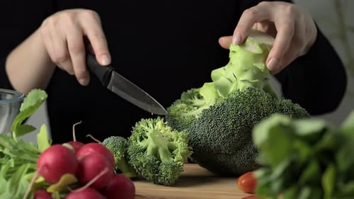 Preparing broccoli for cooking.