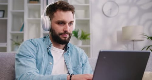 Young Adult Typing on a Laptop at Home