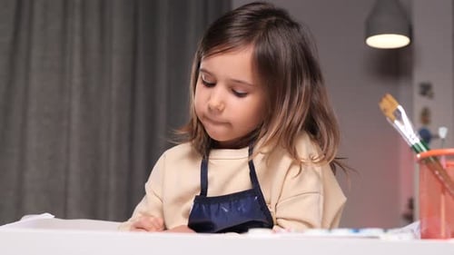 Little Girl Drawing at Table Indoors