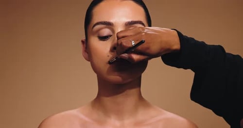 Hands, artist and woman with lipstick in studio for beauty, cosmetics transformation and makeover