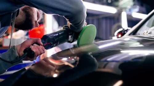 the Car Mechanic at a Service Station Doing the Final Polishing to Shine