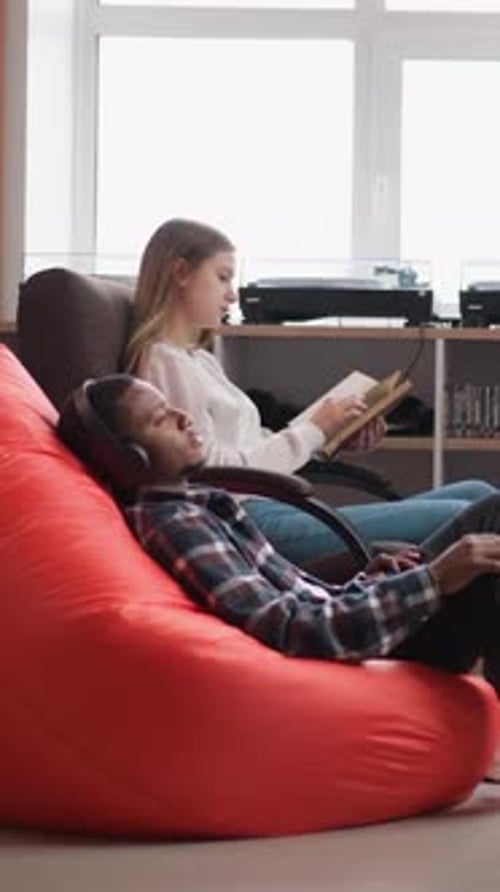 Students Learn Material with Tutor in Library