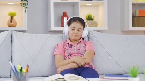 Child with Headphones Listening to Music