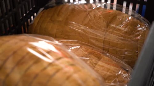 Close up shot of slices of sourdough bread under plastic in a box