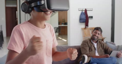 Child Enjoys Virtual Reality with Parent in Living Room